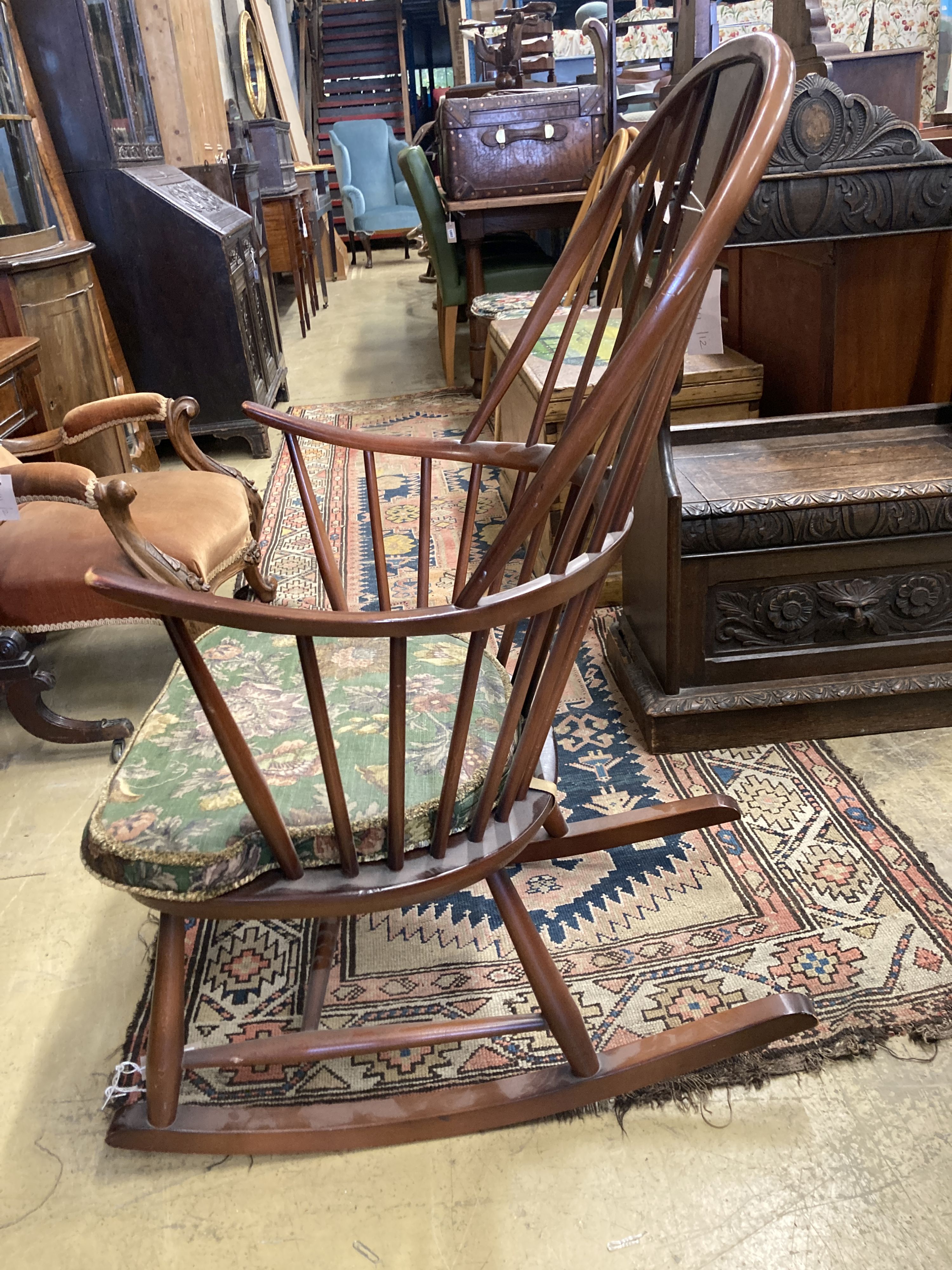 An Ercol comb back stained beech rocking chair, width 60cm, depth 50cm, height 106cm